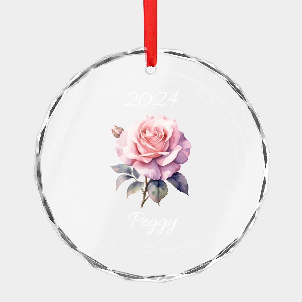 A perfect Christmas gift for mom is the Personalized Birth Month Flower Ornament, showcasing a pink rose design with "2024" above and "Peggy" below. It comes with a red ribbon at the top for easy hanging.