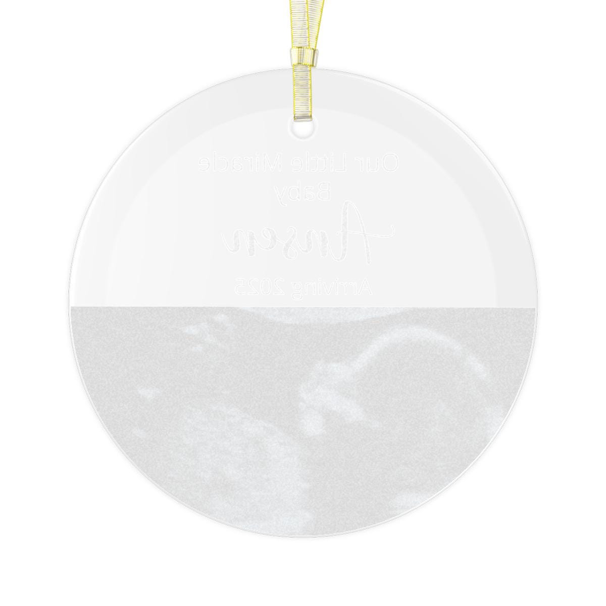 A Custom Ultrasound GLASS Ornament showcases a grayscale image labeled "Our Little Miracle Baby," along with the personalized name "Aspen" and the inscription "Coming 2023." This pregnancy announcement keepsake, complete with a yellow ribbon, is an ideal gift for new parents.