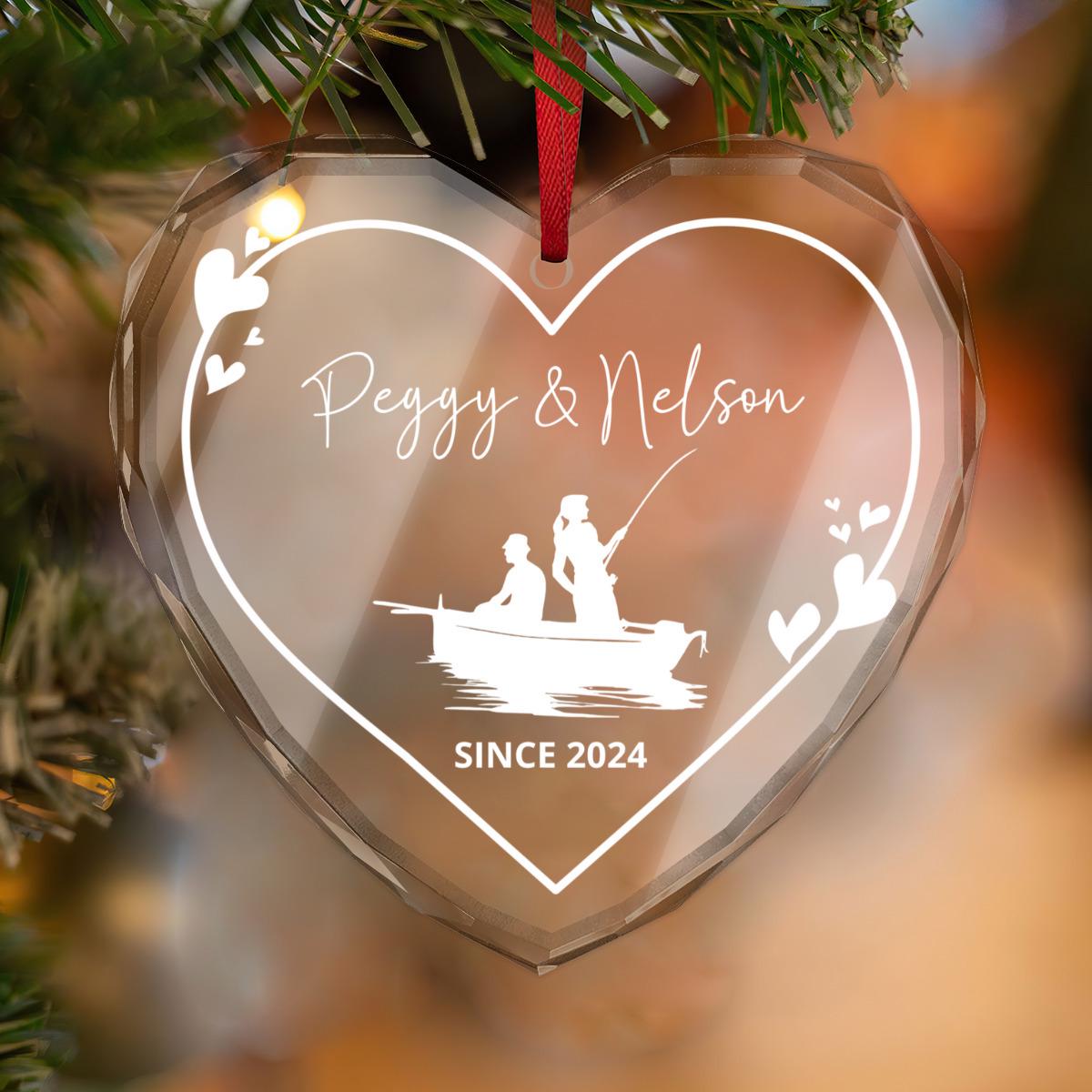 Romantic gift: Heart-shaped Custom Fishing Couple GLASS Ornament with "Peggy & Nelson" and "Since 2024," featuring a couple on a boat silhouette—a personalized fisherman's keepsake for engagement or wedding anniversary.