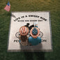 Two people wearing American flag hats lounge on a grassy patch with a Personalized Life Is A Sweet Ride Cycling Couple Heirloom Woven Blanket, which reads, "Life is a sweet ride with you every day." An American flag adds to the personalized, cherished scene.