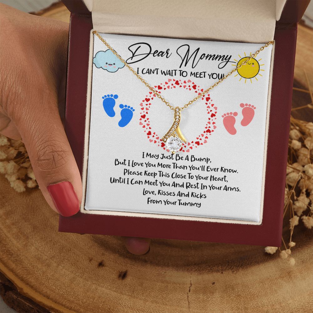 A hand holding a To New Mom - I Can't Wait to Meet You - Alluring Beauty Necklace with a poem on it by ShineOn Fulfillment.