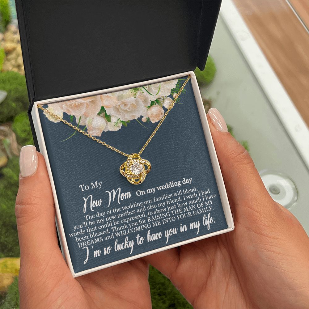A person holding a ShineOn Fulfillment To My New Mom - I am so lucky to have you in my life - Love Knot Necklace gift box.