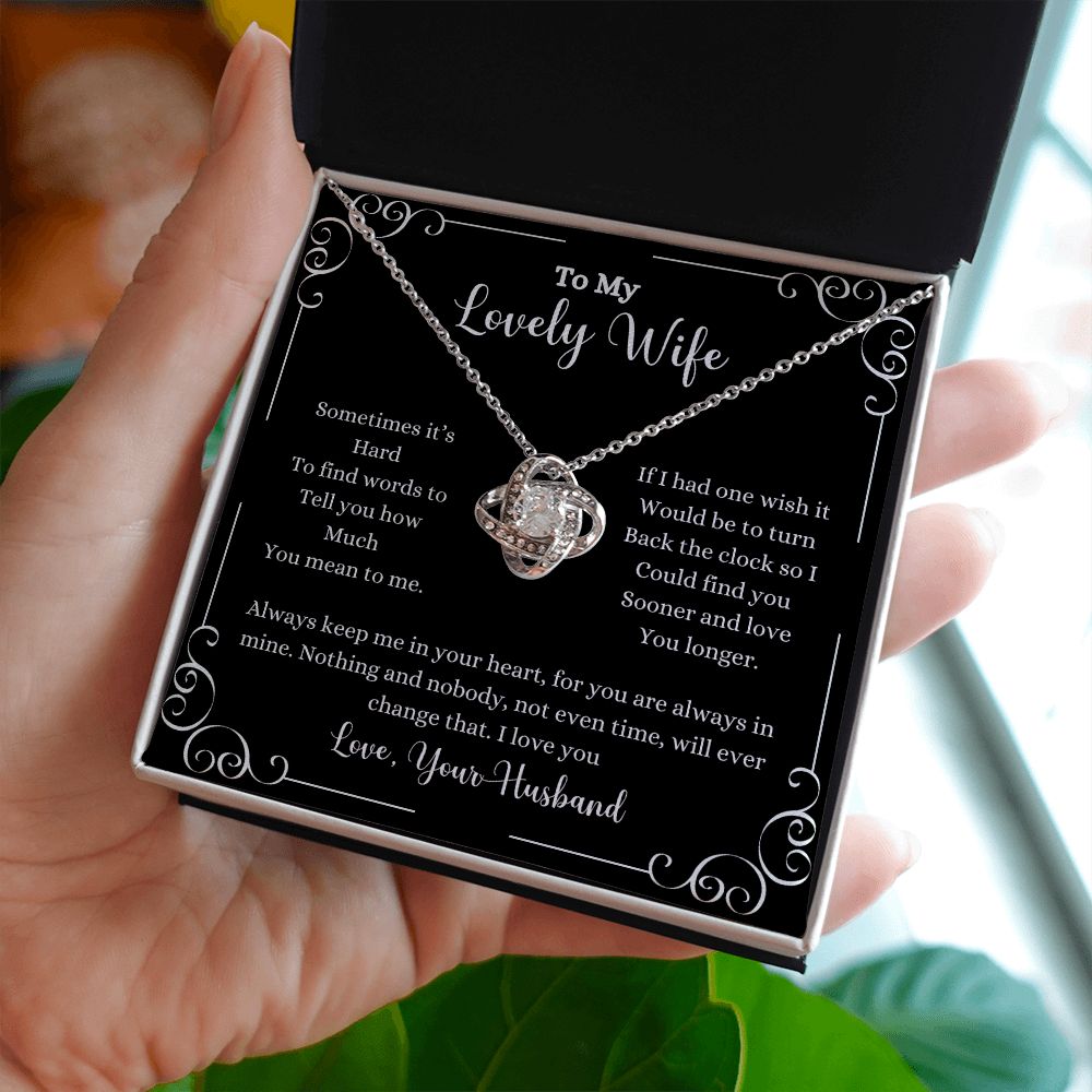 A woman holding a "I Love You Love Knot Necklace - Gift for Wife from Husband" by ShineOn Fulfillment, with a poem on it.
