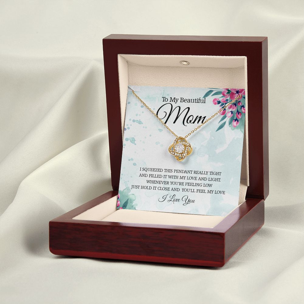 A wooden box with the I Squeezed This Pendant Love Knot Necklace - For Mom by ShineOn Fulfillment in it.