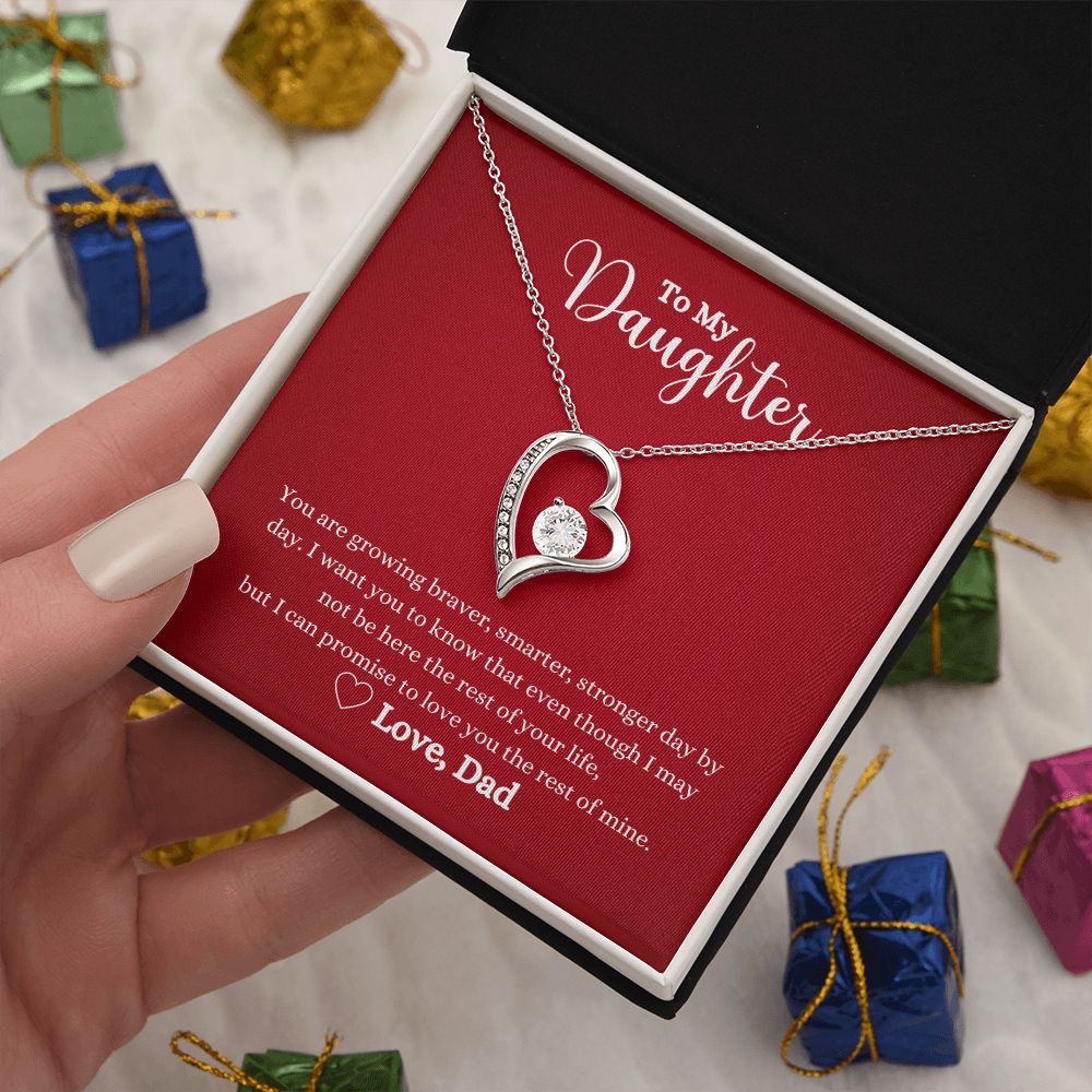 A hand holding a Love You The Rest of Mine Forever Love Necklace - Gift for Daughter from Dad by ShineOn Fulfillment in a gift box.