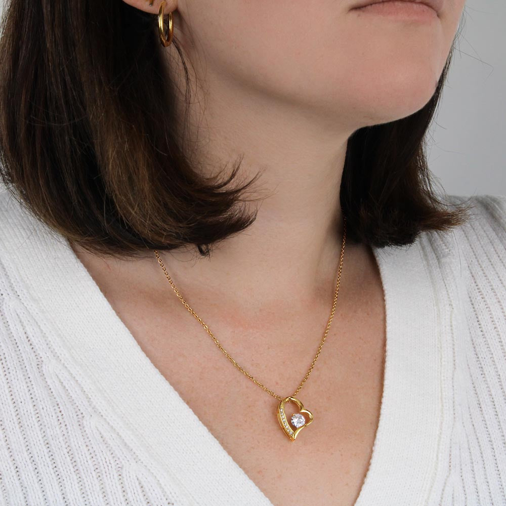 A woman wearing a "To My Bonus Mom - Thank You For Always Being There - Forever Love Necklace" by ShineOn Fulfillment with a heart shaped pendant.