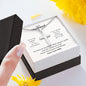 A person is holding a I'M So Truly Grateful Artisan Cross Necklace – For Husband from ShineOn Fulfillment in a gift box.