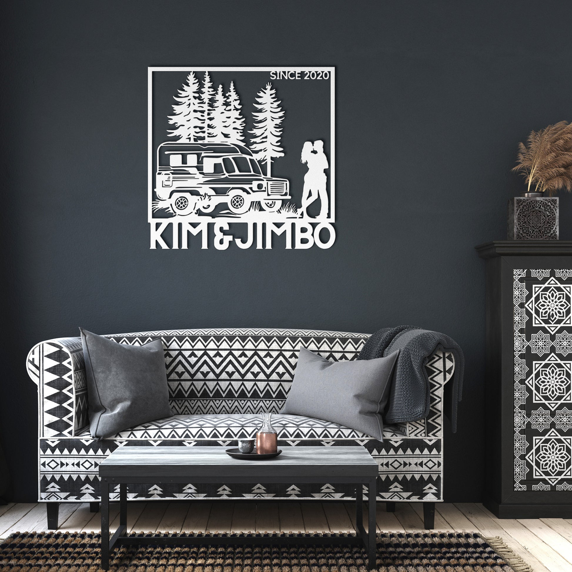 The Camping Couple Metal Art features a silhouette of a camper van, trees, and a couple embracing, with the text "Kim & Jimbo" below and "Since 2020" in the top right corner. This powder-coated metal sign makes for charming home decor.