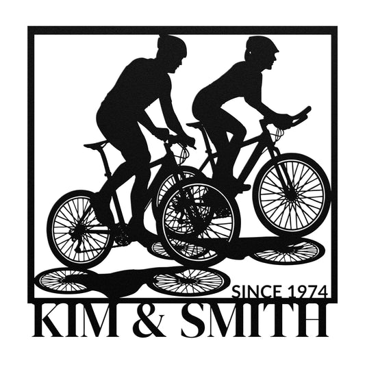 The Couple Cycling Together Metal Art features a silhouette of two cyclists with "Kim & Smith Since 1974" text, beautifully crafted on a powder-coated metal sign that serves as stylish home decor.