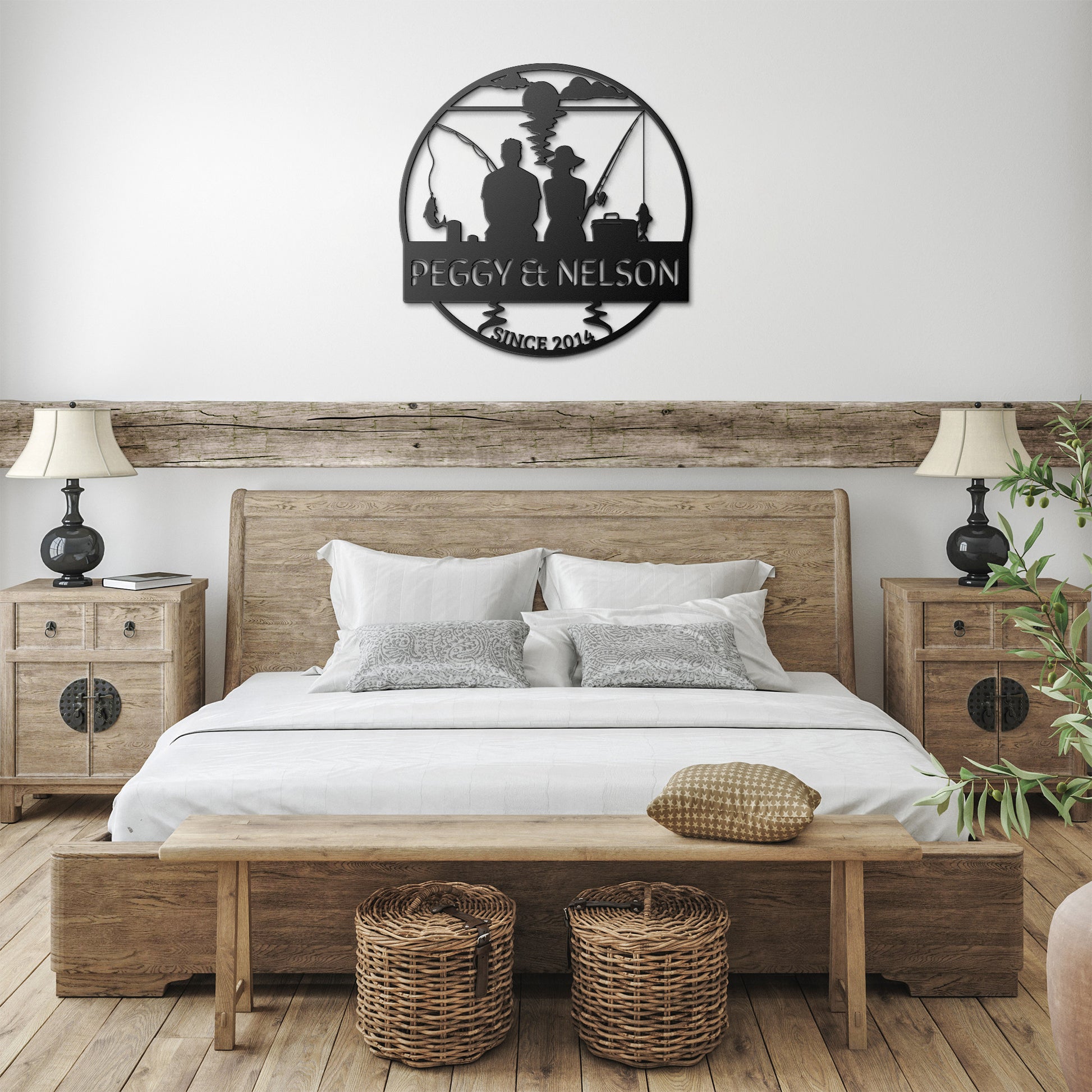 A rustic bedroom features a wooden bed, matching nightstands and lamps, and decorative wall art above the bed. Adding a touch of unique home decor, the "Couple Fishing Together Metal Wall Art," made from 18 gauge steel, complements the setting. Two wicker baskets are placed under a bench at the foot of the bed.