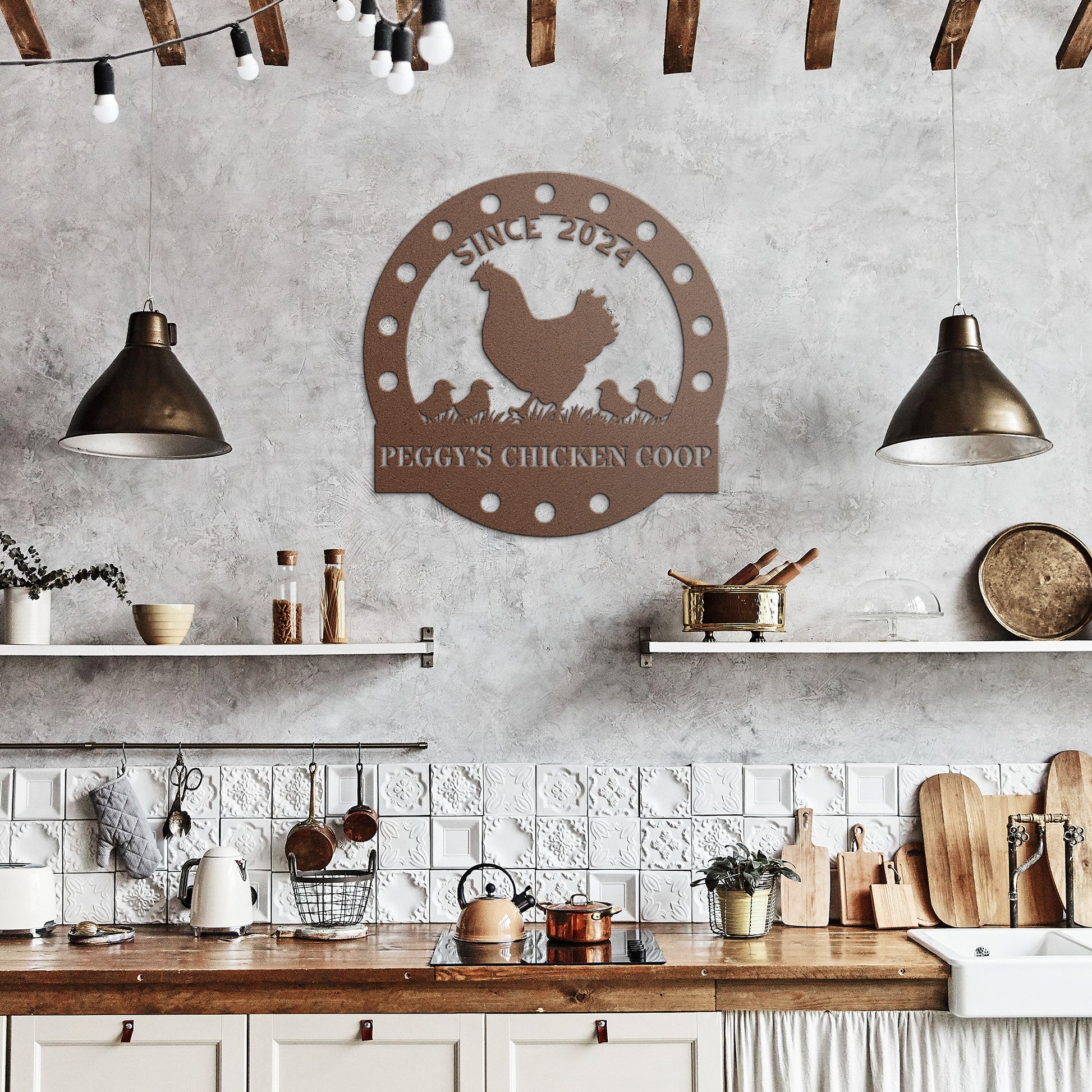 A rustic kitchen featuring white tiles and wooden shelves showcases a "Custom Chicken Coop Metal Sign" crafted from 18-gauge steel with a charming chicken design and the phrase "Peggy's Chicken Coop." Hanging lights above the sink illuminate various kitchen items, enhancing the charm of this delightful home decor setting.