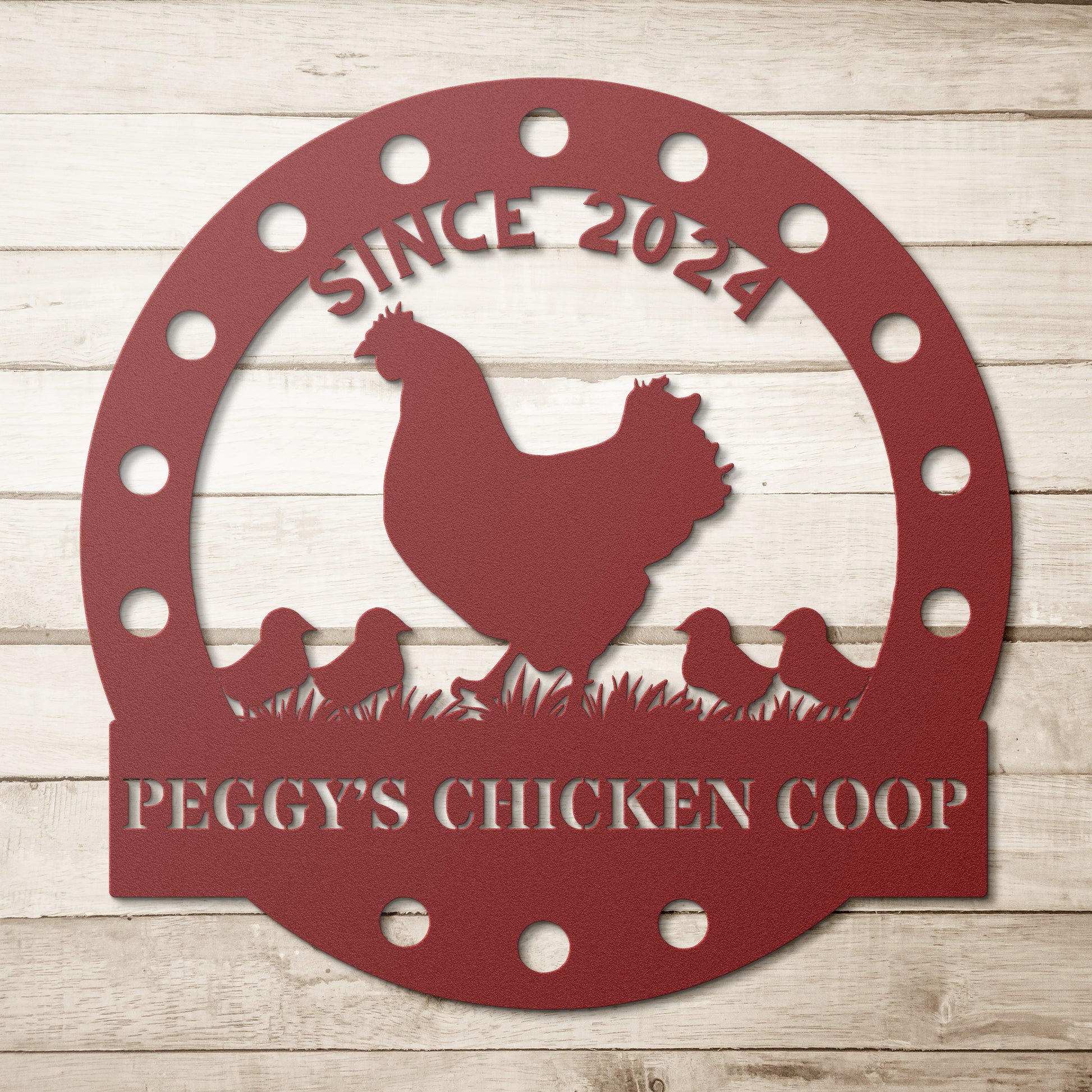The Custom Chicken Coop Metal Sign is crafted from 18 gauge red steel, featuring a charming silhouette of a chicken and chicks on grass. It reads "Since 2024 Peggy's Chicken Coop" and is perfect for adding rustic charm to your home decor.