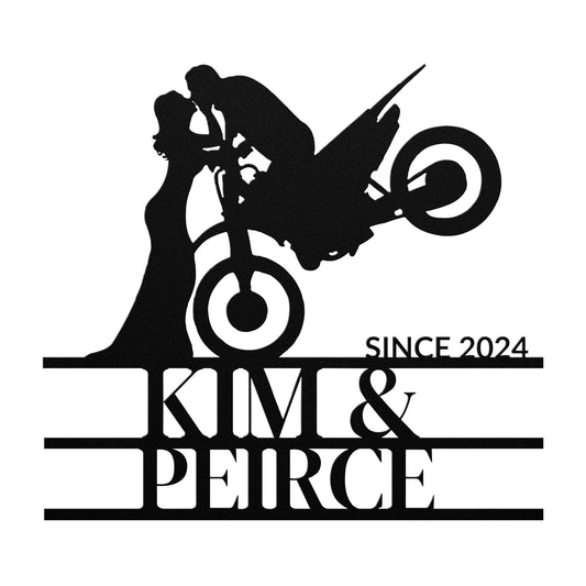 Silhouette of a couple kissing with a Custom Motorcycle Couple Metal Wall Art sign in the air above them, with the text "since 2024 kim & peirce" below.