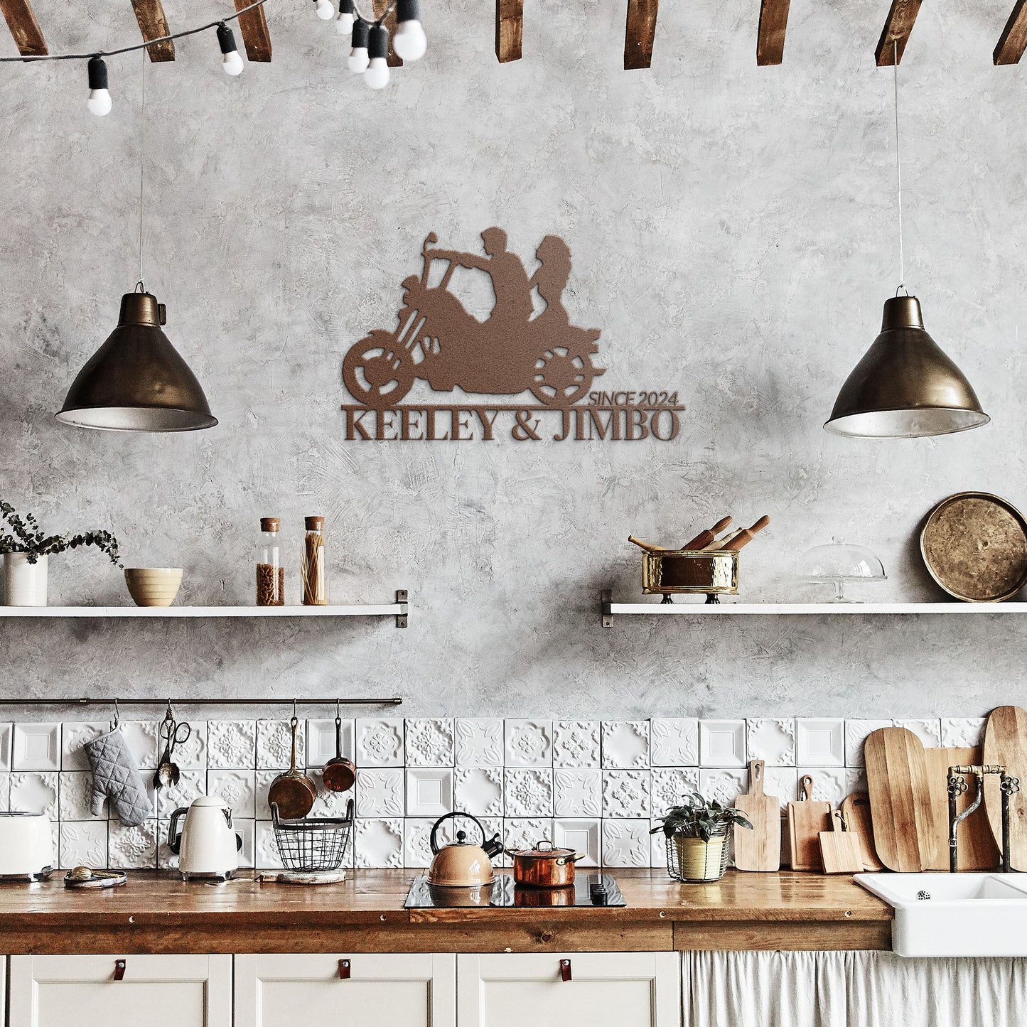 A rustic kitchen featuring wooden beams, two pendant lights, open shelves, and a Custom Motorcycle Couple Metallic Wall Art crafted from 18-gauge steel with the label "Keeley & Jimbo Since 2024.