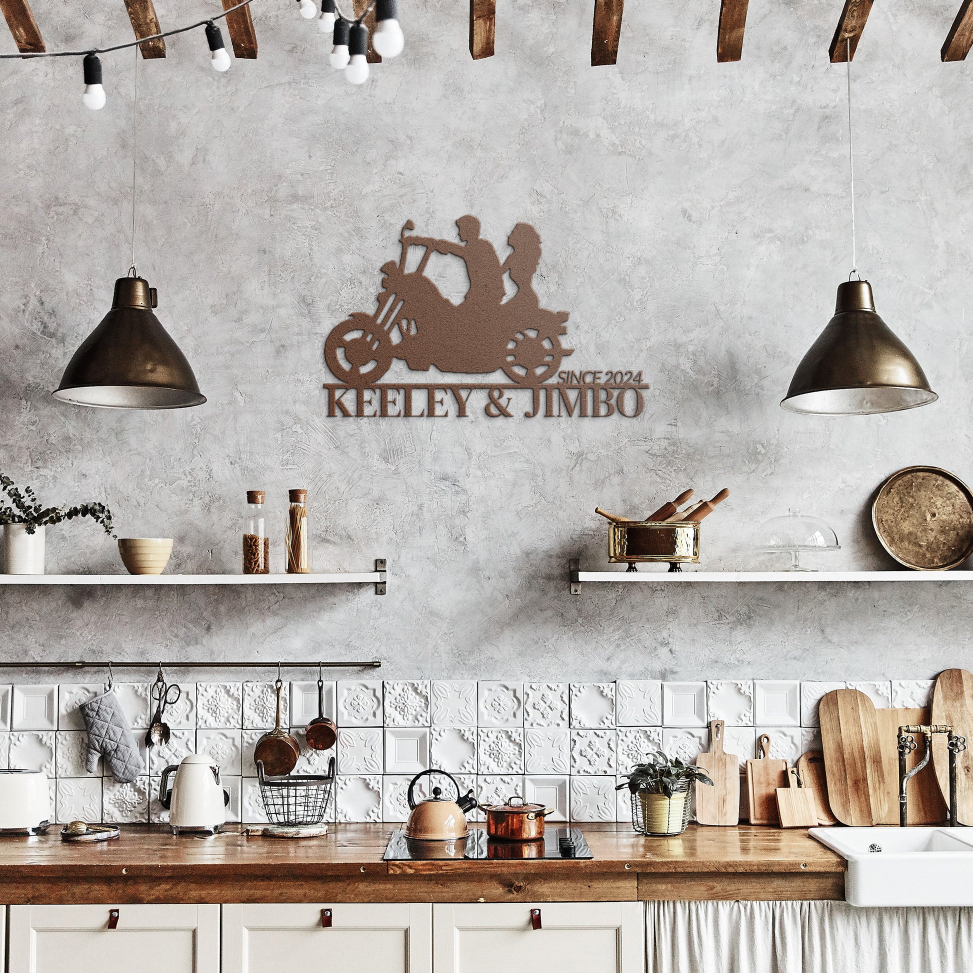 A rustic kitchen featuring wooden beams, two pendant lights, open shelves, and a Custom Motorcycle Couple Metallic Wall Art crafted from 18-gauge steel with the label "Keeley & Jimbo Since 2024.