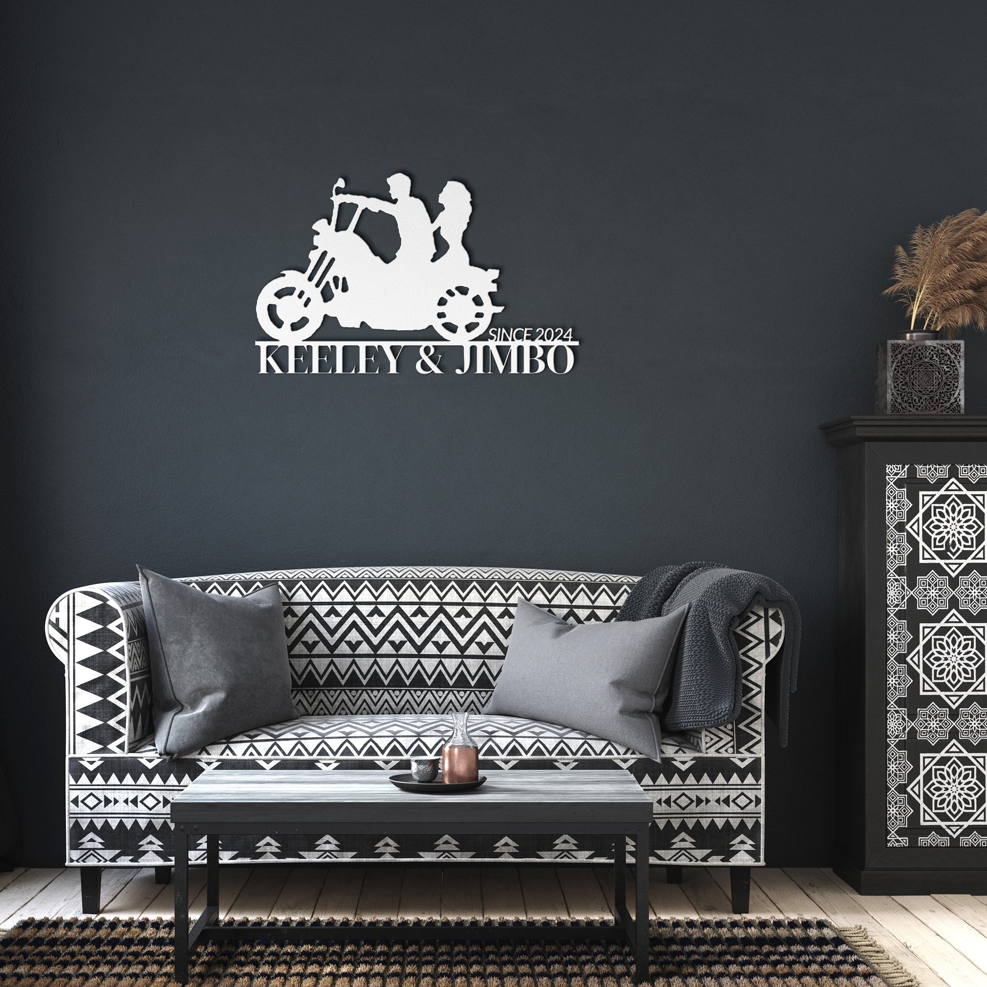 Silhouette of a couple riding a motorcycle with the text "KEELEY & JIMBO" and "SINCE 2024" below them, crafted from premium 18 gauge steel. This striking Custom Motorcycle Couple Metallic Wall Art makes for perfect home decor.

