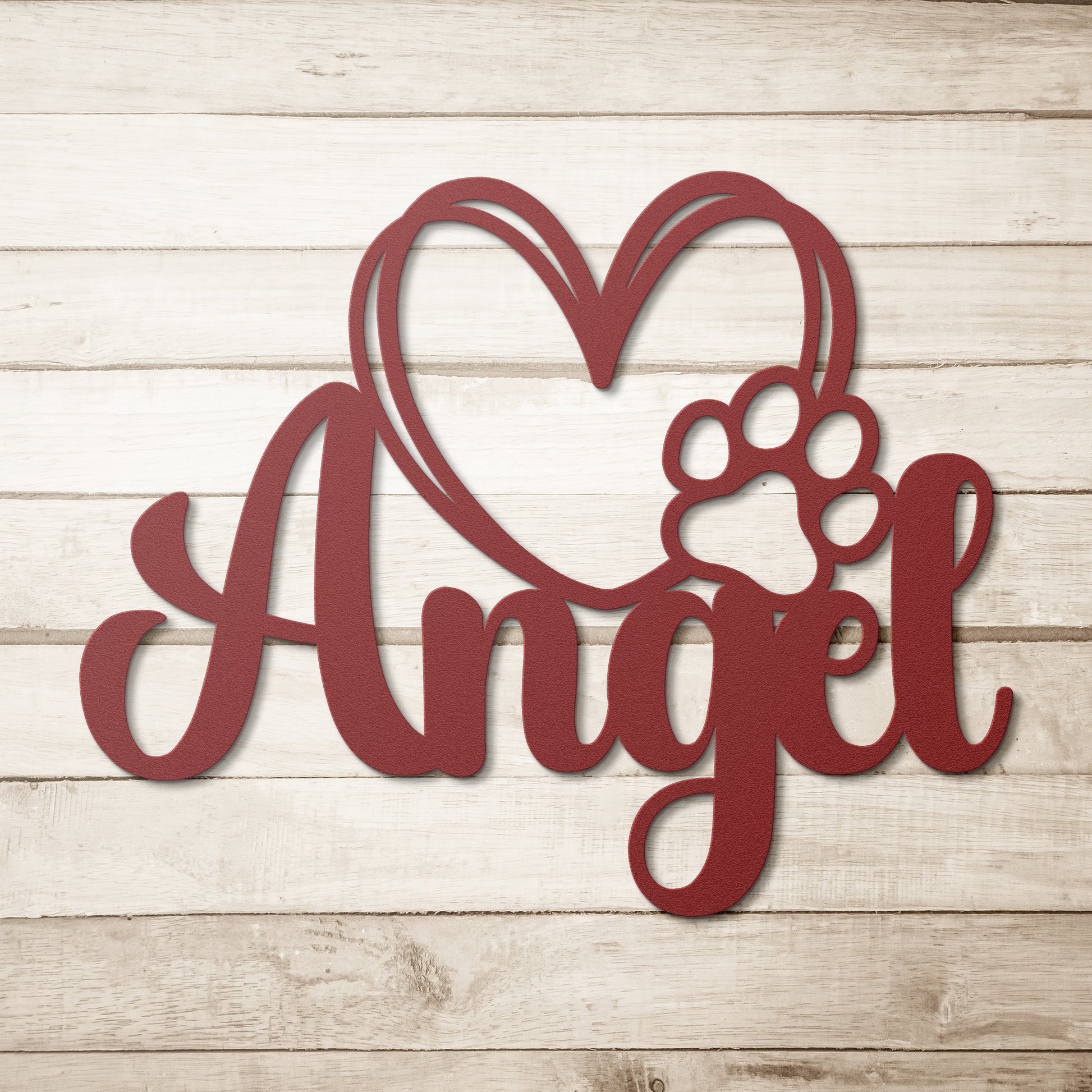 A wooden door with a glass panel in the center is set in a brick wall. To the left of the door is a potted plant with white flowers, and an 18 gauge steel sign that reads "Angel" with a heart and pawprint adds charm to the home decor. This unique touch is provided by the Custom Pet Name Metal Sign with Heart and Paw.