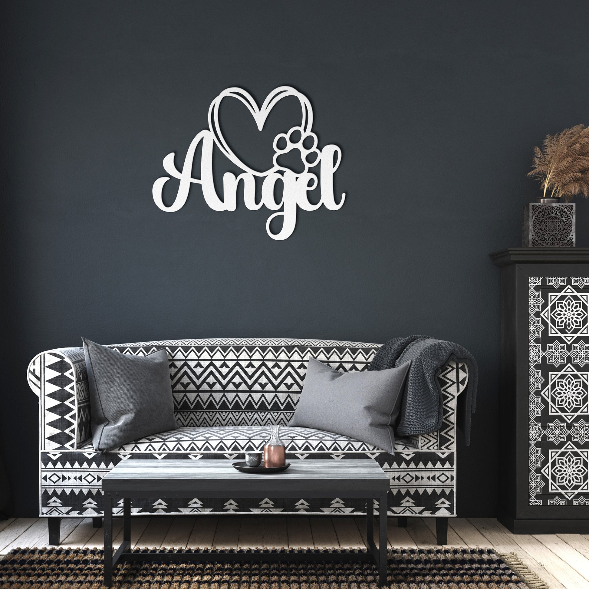 A wooden door with a glass panel in the center is set in a brick wall. To the left of the door is a potted plant with white flowers, and an 18 gauge steel sign that reads "Angel" with a heart and pawprint adds charm to the home decor. This unique touch is provided by the Custom Pet Name Metal Sign with Heart and Paw.