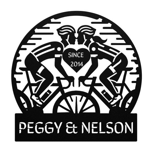 The Cycling Couple Metal Sign showcases a delightful silhouette of two cyclists facing each other, with "Since 2014" beautifully enclosed in a heart. Its powder-coated finish lends an elegant touch, while the personalized text reads "Peggy & Nelson," making it an ideal addition to your home decor for a personal touch.