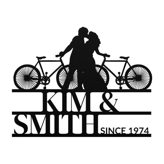 Cycling Couple Metal Sign: Powder-coated metal silhouette of a couple with bicycles above the text "Kim & Smith Since 1974.