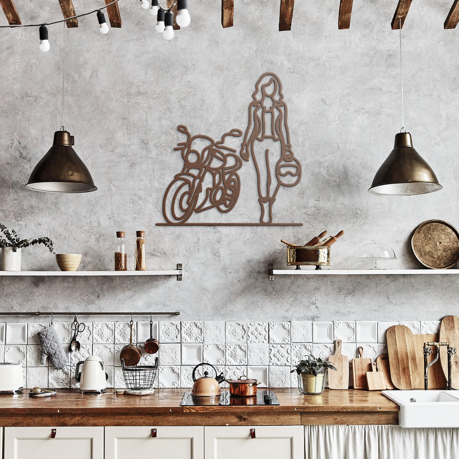 Industrial kitchen interior features low-hanging lights, exposed beams, and shelves. Wall decor includes the edgy FEMALE BIKER LINE ART, showcasing a powder-coated metal outline of a woman with a motorcycle helmet standing by a bike.