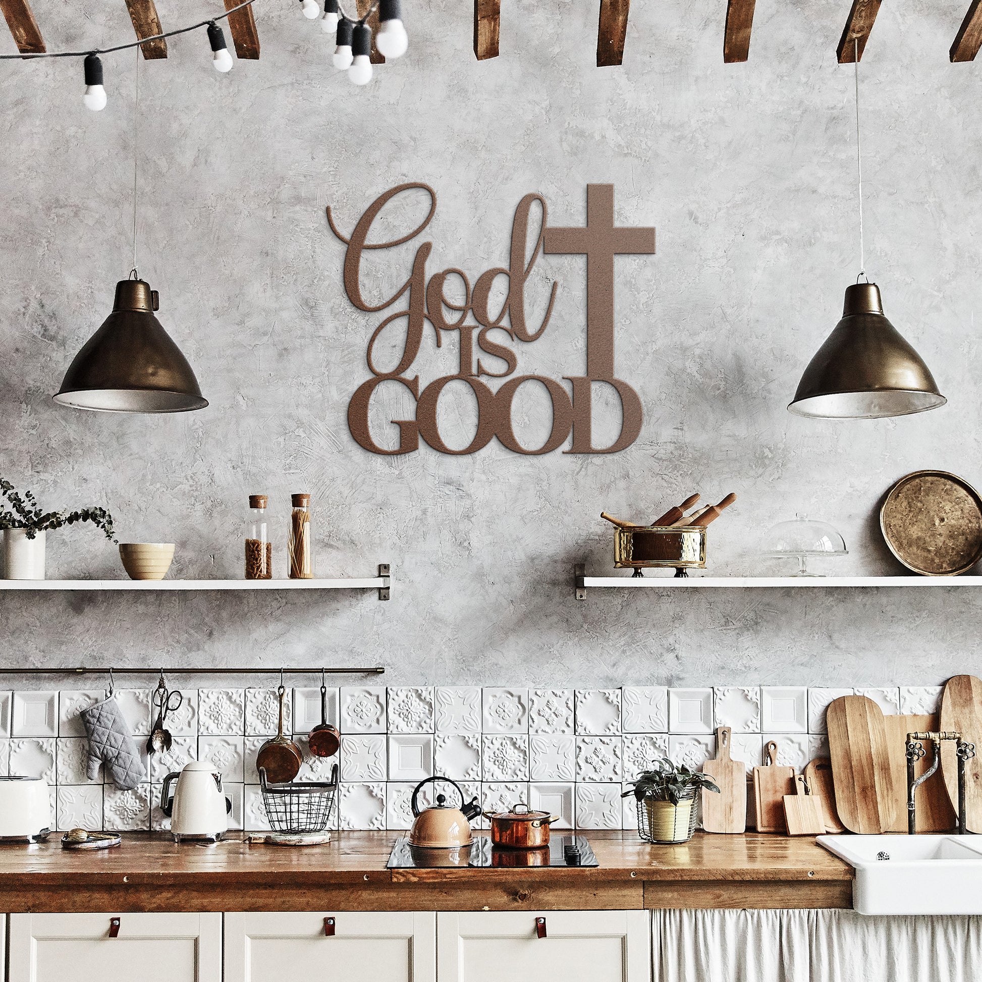 A brown wooden door with decorative glass is set in a brick wall. A potted plant sits beside it, and a stylish powder-coated sign "God Is Good Christian Metal Art" next to a cross enhances the decor. A black outdoor lamp hangs above the sign, completing the charming home decor scene.