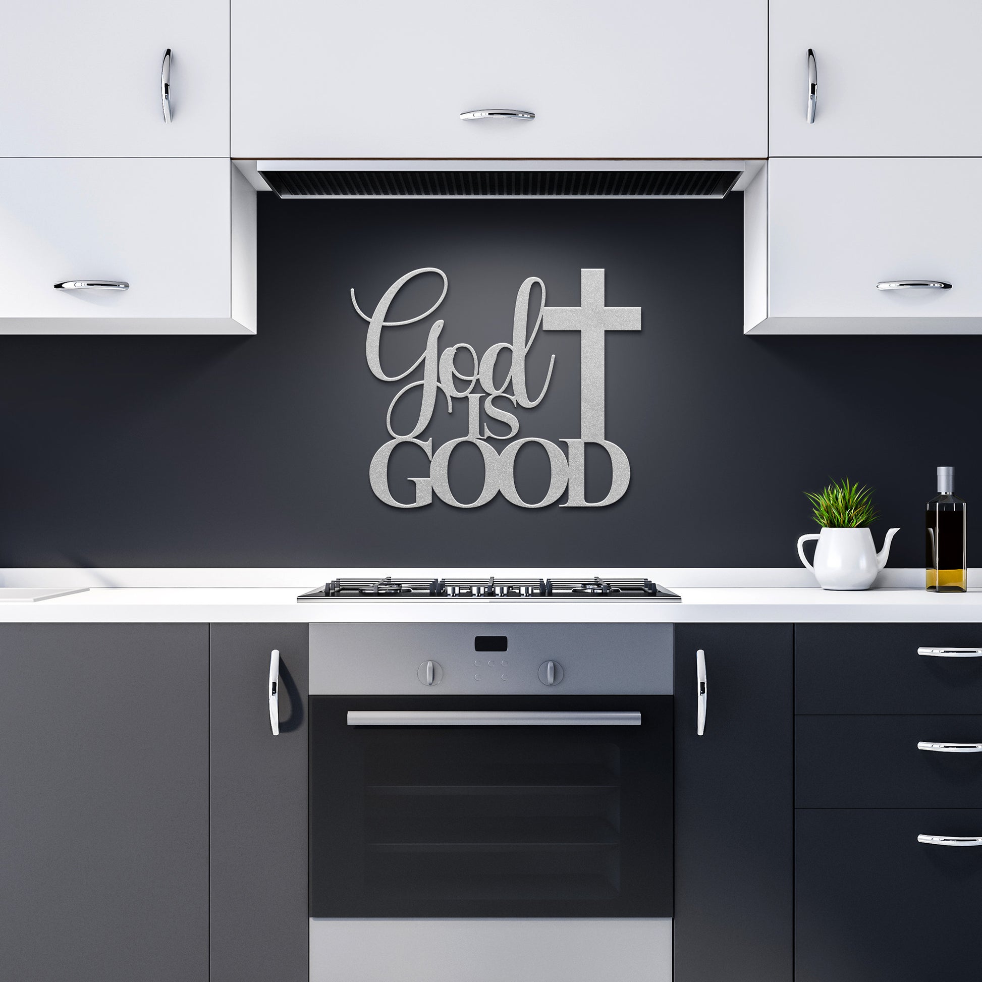 Modern kitchen with white and black cabinets, a silver oven, and the "God Is Good Christian Metal Art" sign next to a cross.