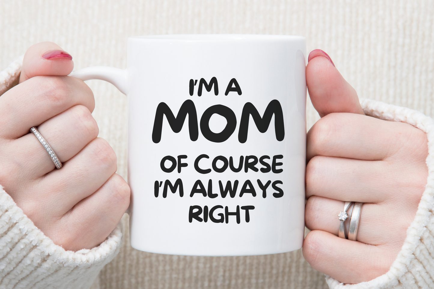 Hands holding a white mug with the text: "I'm a MOM. Of course I'm always right." This humorous coffee mug, "I'm A Mom Of Course I’m Always Right," is the ideal gift to remind her she’s got the last word.