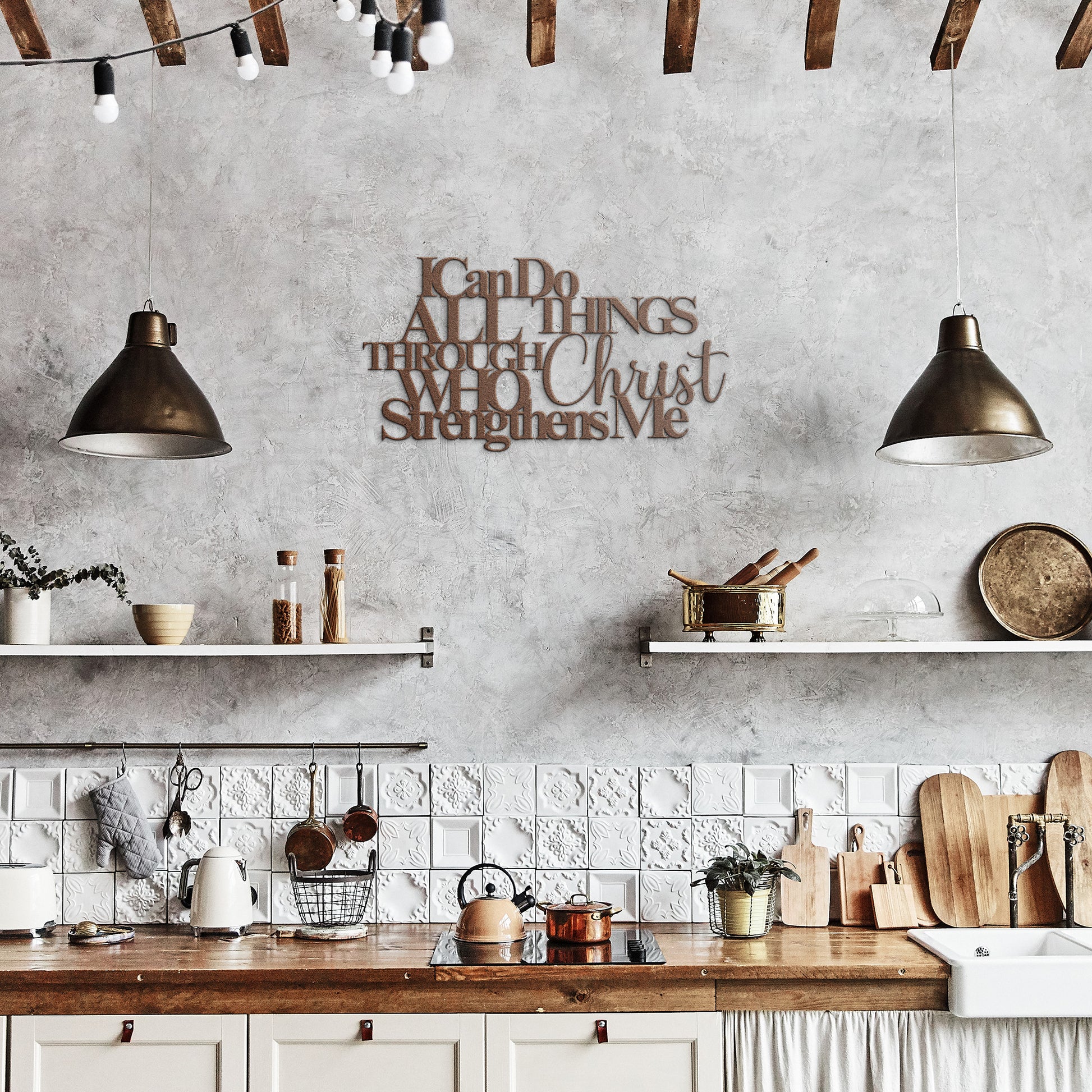 A rustic kitchen features hanging pendant lights, wooden shelves with various kitchen items, and an "I Can Do All Things Through Christ Who Strengthens Me Christian Metal Sign" on the wall, adding a touch of spiritual home decor.