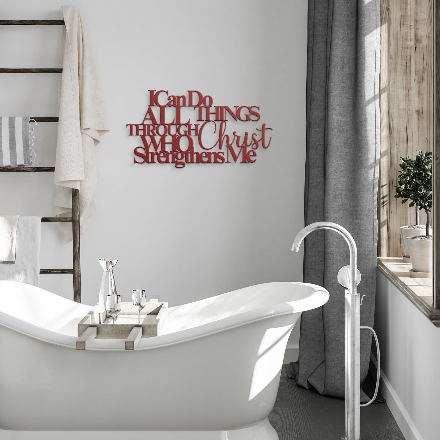 A white freestanding bathtub in a bathroom with towels on a ladder shelf and an "I Can Do All Things Through Christ Who Strengthens Me Christian Metal Sign.