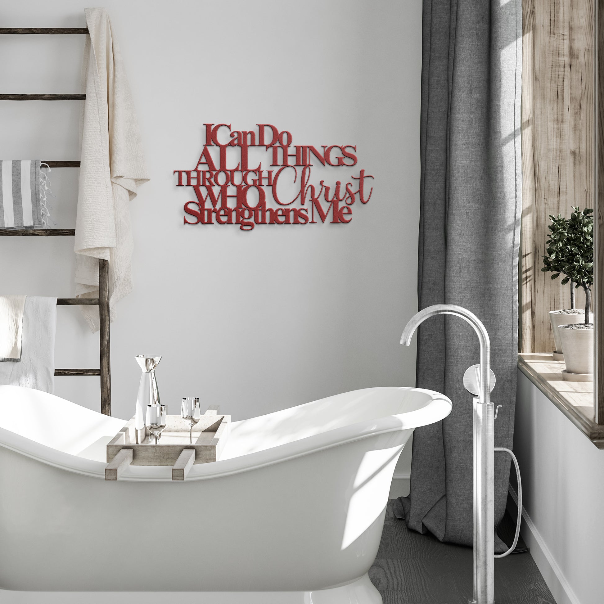 A white freestanding bathtub in a bathroom with towels on a ladder shelf and an "I Can Do All Things Through Christ Who Strengthens Me Christian Metal Sign.