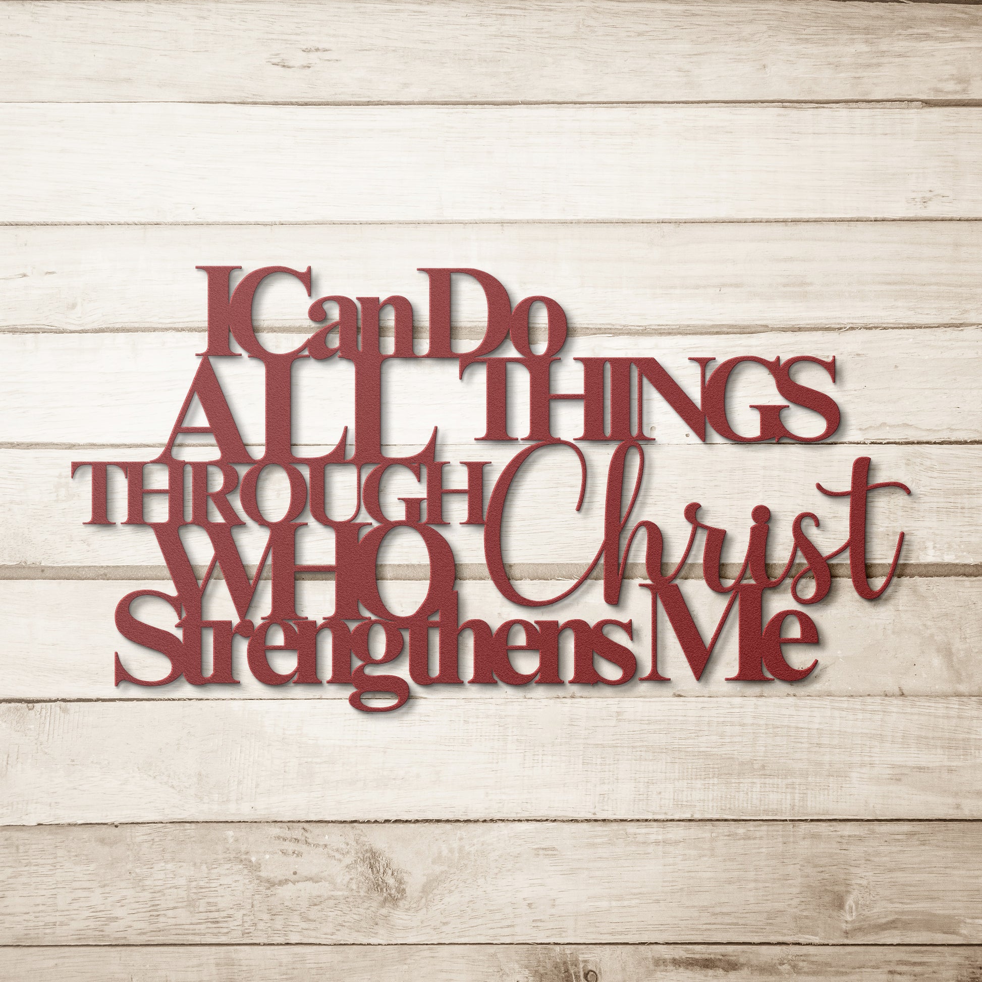 A Christian metal sign with the text "I Can Do All Things Through Christ Who Strengthens Me" in red letters against a light wood background adds a touch of inspiring home decor.