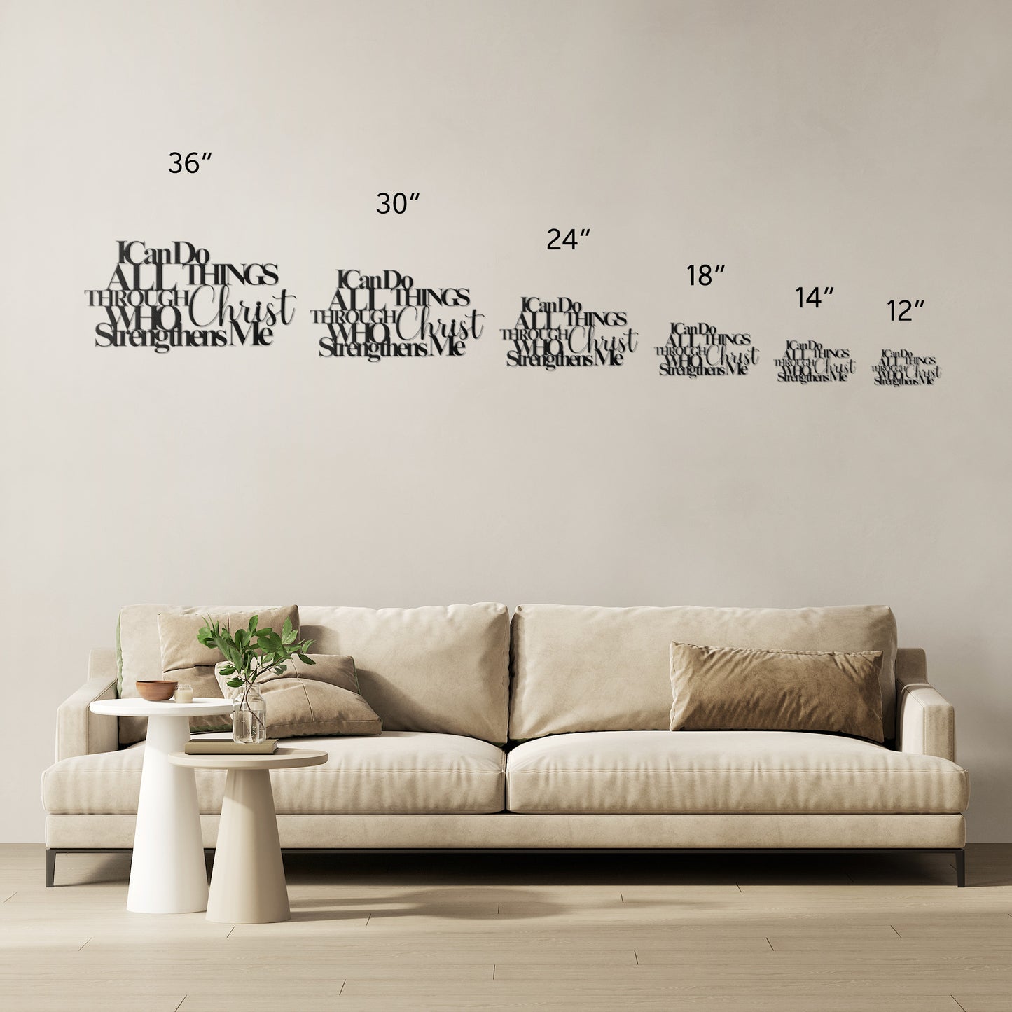 A beige sofa with multiple cushions is placed against a wall adorned with home decor, including decals of various sizes and an 18-gauge steel "I Can Do All Things Through Christ Who Strengthens Me Christian Metal Sign," alongside measurement markings.