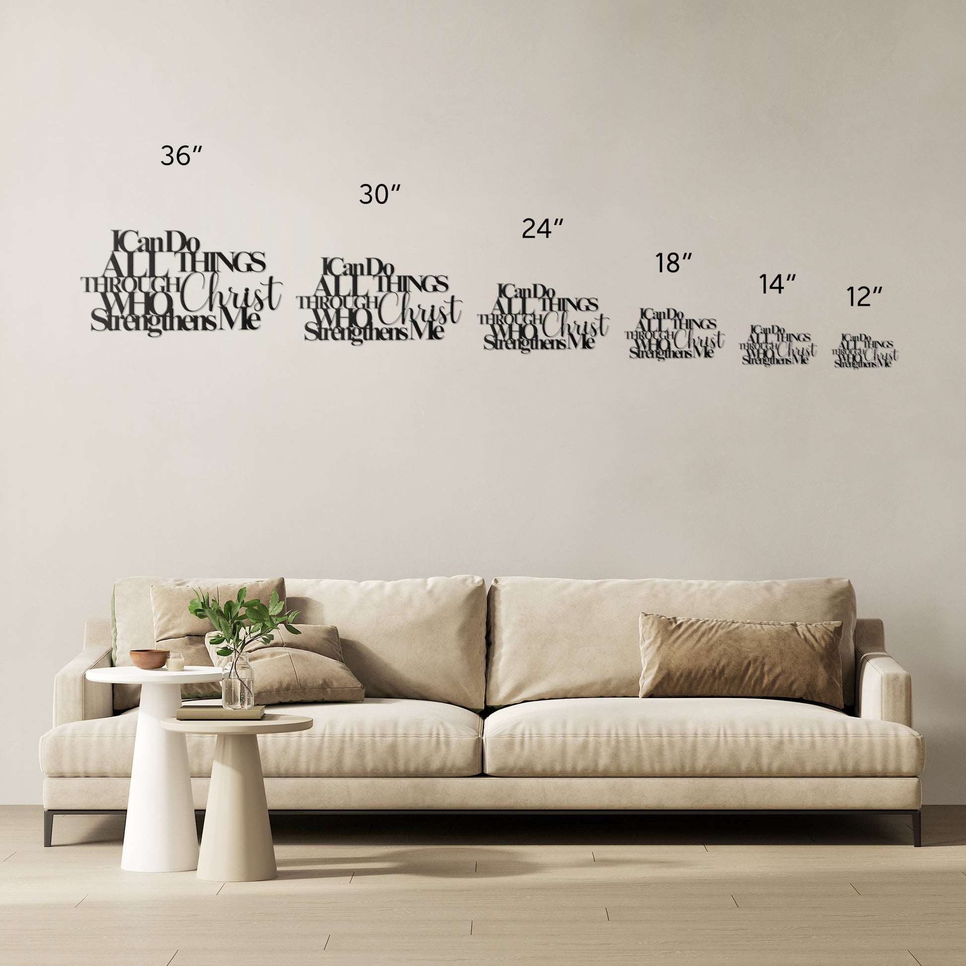 A beige sofa with multiple cushions is placed against a wall adorned with home decor, including decals of various sizes and an 18-gauge steel "I Can Do All Things Through Christ Who Strengthens Me Christian Metal Sign," alongside measurement markings.