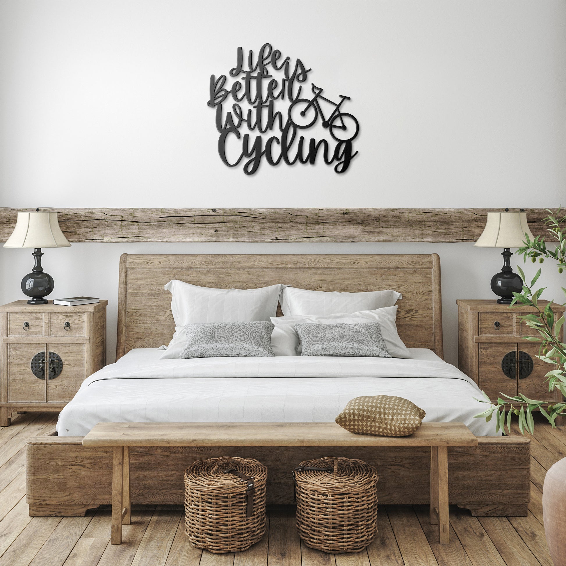 A brick wall with a wooden door, a potted plant, a black outdoor light, and the "Life is Better with Cycling Metal Sign - Road Bike Edition," reading "Life's Better with Cycling" alongside a bicycle graphic, perfect for stylish home decor.