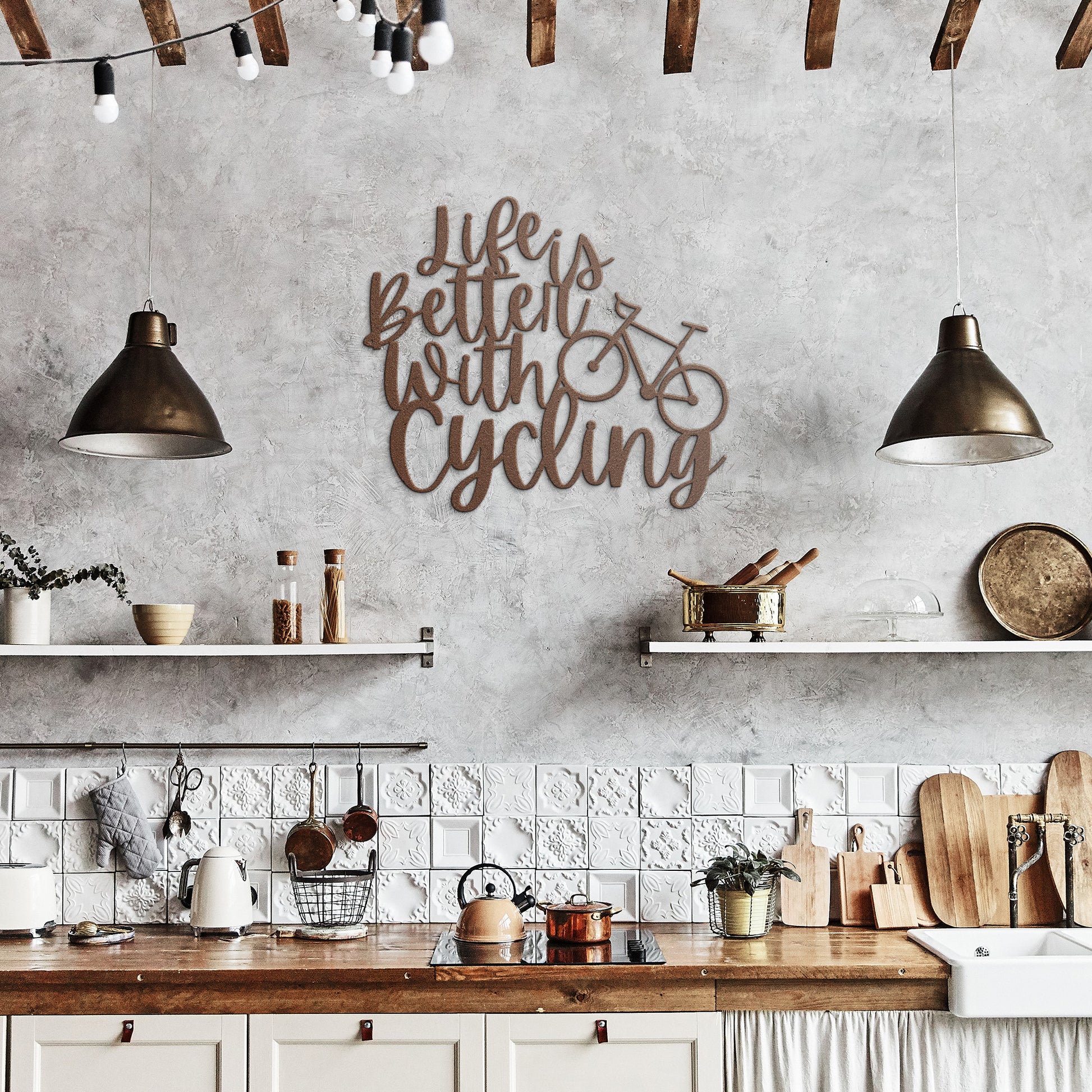 A brick wall with a wooden door, a potted plant, a black outdoor light, and the "Life is Better with Cycling Metal Sign - Road Bike Edition," reading "Life's Better with Cycling" alongside a bicycle graphic, perfect for stylish home decor.