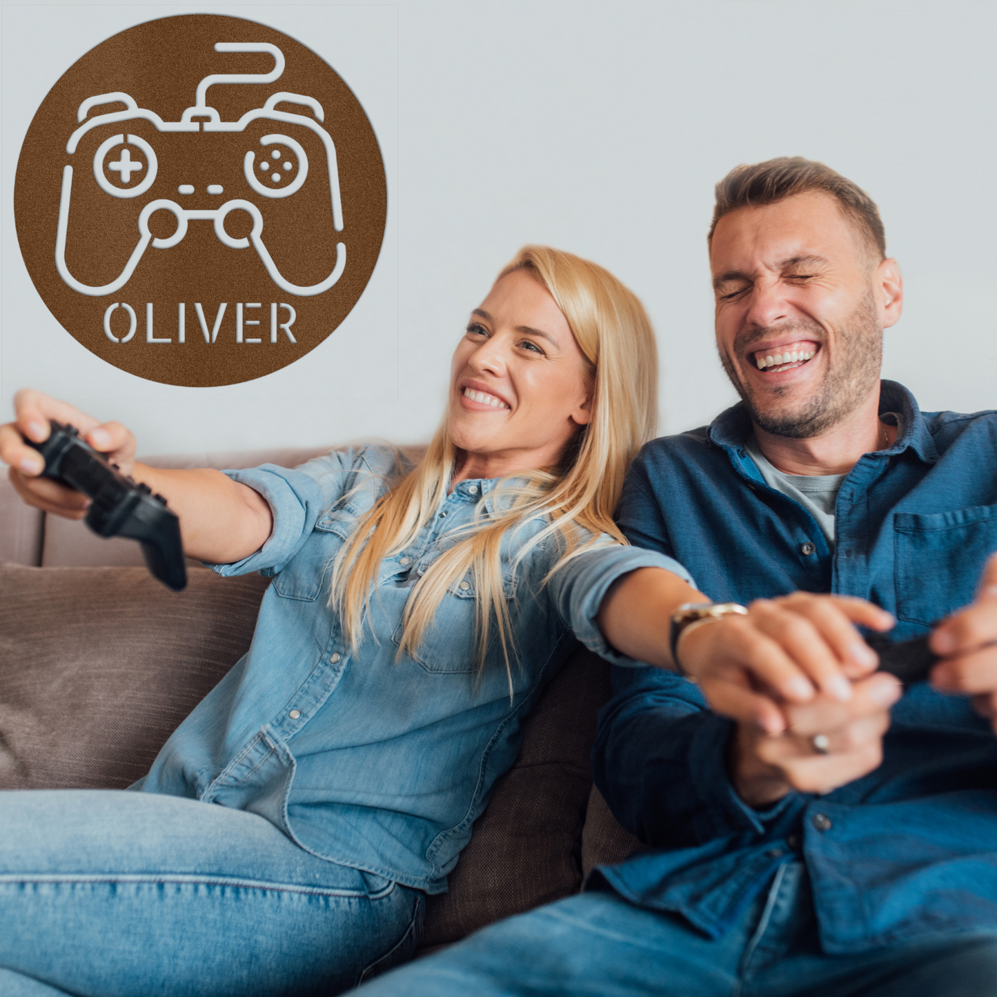A smiling couple plays video games on a couch, each holding controllers. Behind them, a Personalized Gamer Controller Metal Sign with "OLIVER" adds unique metal wall decor to their space.