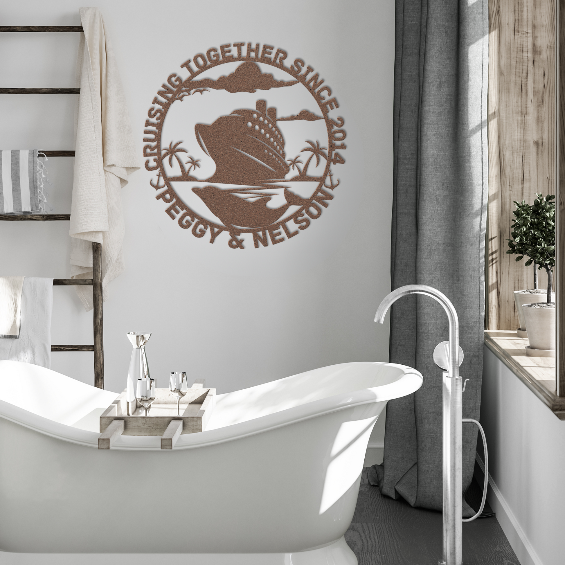 A modern bathroom with a white freestanding tub, wooden ladder towel rack, and the Personalized Cruise Couples Metal Wall Art - Tropical Cruise, customized with cruise ship, palm trees, and "CRUISING TOGETHER SINCE 2014, PEGGY & NELSON.