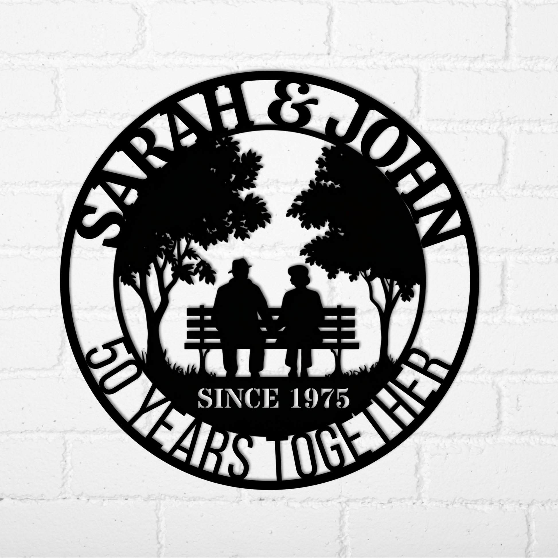 Personalized 50th Wedding Anniversary Metal Wall Art—custom black metal sign showing two people on a bench under trees, with “SARAH & JOHN” above and “50 YEARS TOGETHER SINCE 1975” below. Perfect for unique anniversary decor.