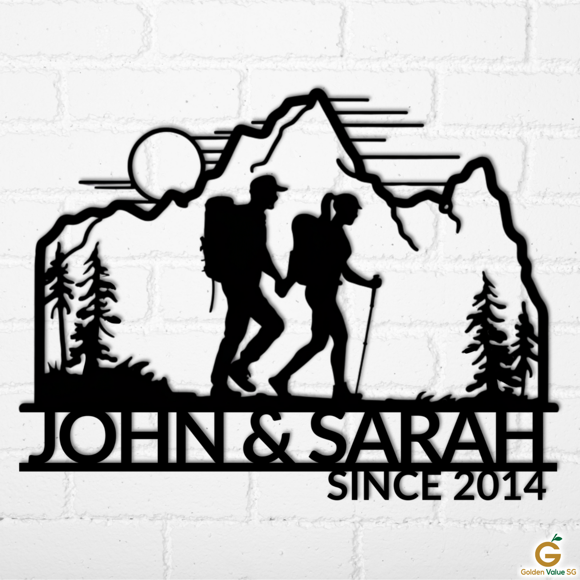 Personalized Hiking Couple Metal Wall Art features a man and woman hiking with backpacks, mountains, trees, and sun, plus custom text like "JOHN & SARAH SINCE 2014." Unique metal decor for your home. Shown on a white brick wall.