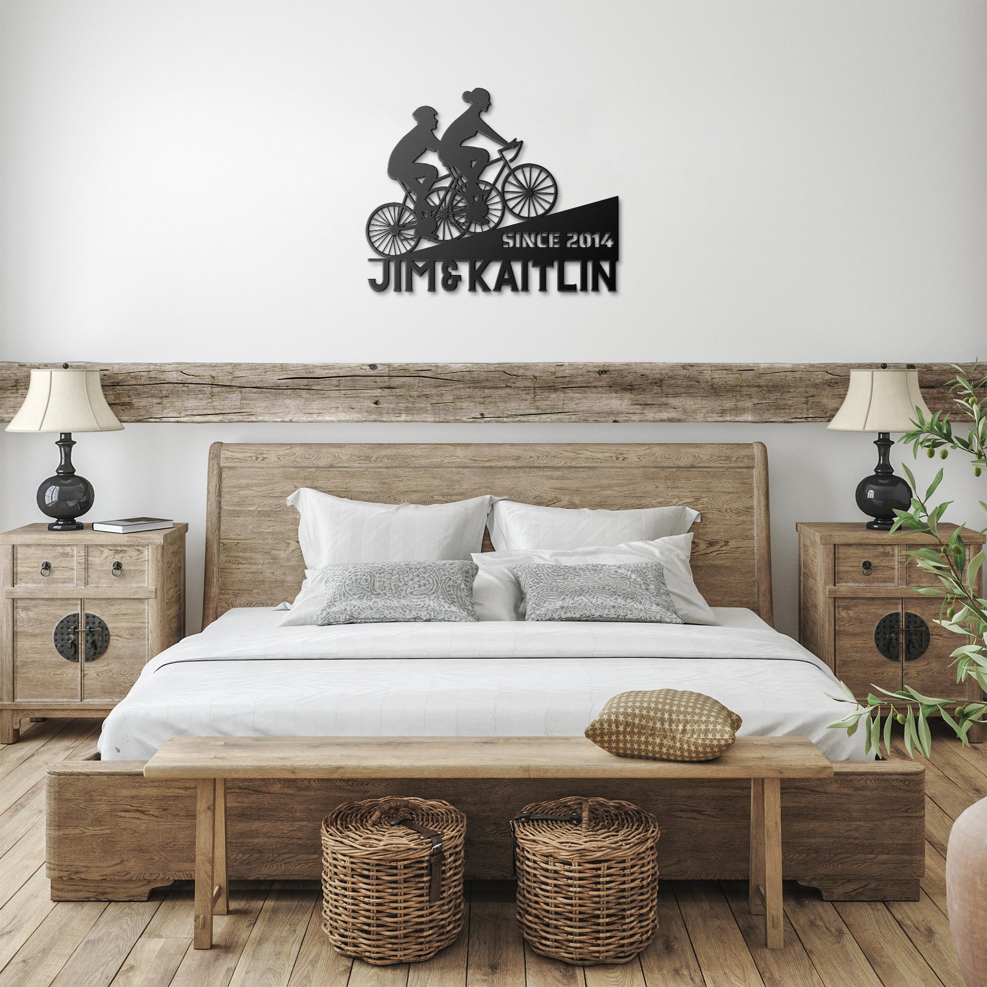 A bedroom with a bed and a teelaunch Personalized Couple Cycling Uphill Metal Wall Art Sign.