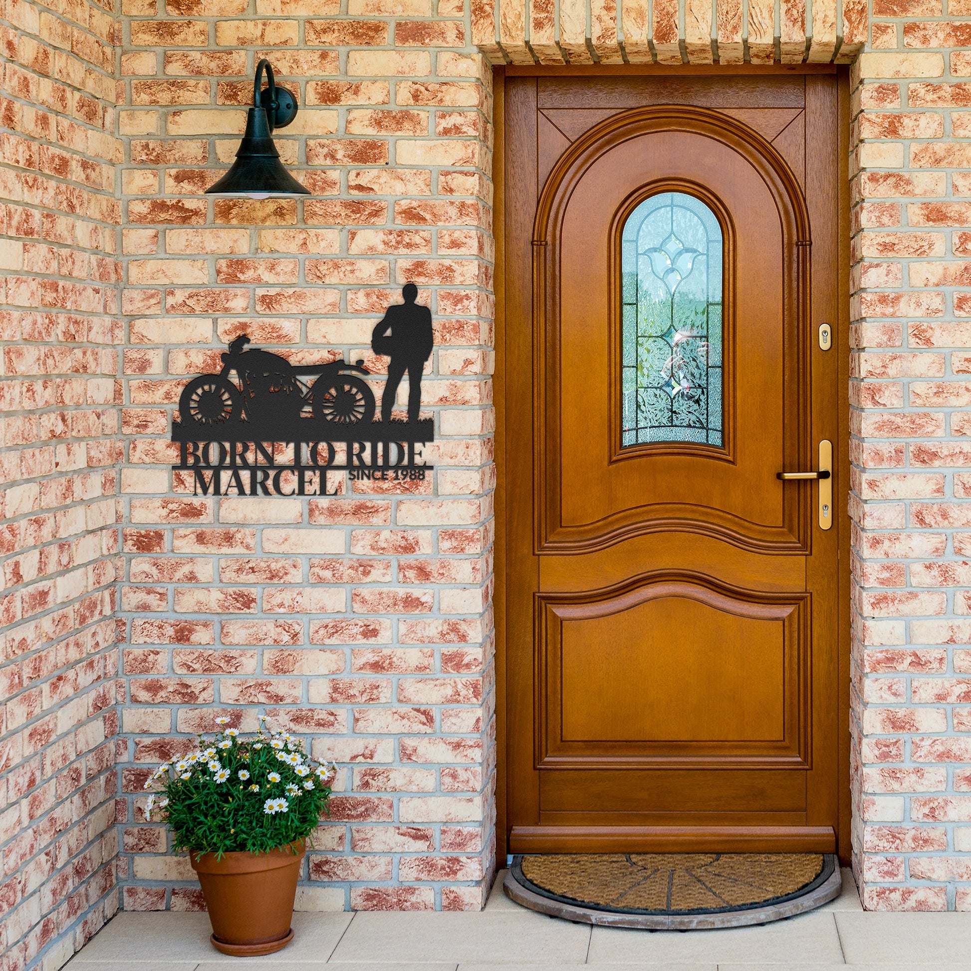 A wooden front door with a stained glass window, adorned with an 18 gauge steel Personalized Gift For Cyclist - Cycling Metal Wall Art Sign on a brick wall next to a potted plant and a bell.