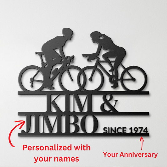 Personalized custom cyclist couple metal wall art sign featuring two cyclists and customized text "kim & jimbo since 1974", with annotations for customization options.
