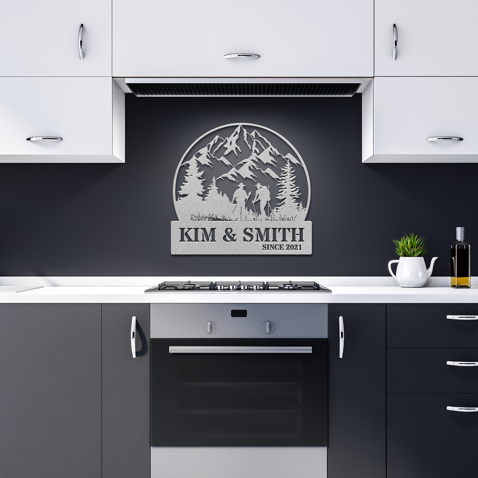 A brick house exterior with a wooden door, arched stained glass, wall-mounted lamp, potted flowers, and an 18 gauge steel decor sign reading "Kim & Smith," featuring the Updated Hiking Couple Metal Art with a mountain and tree silhouette that serves as a timeless piece of home decor.