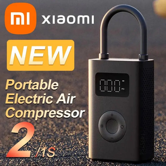New Xiaomi Mijia Air Pump 2 on a rough surface, featuring digital tire pressure detection and a control button.