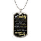 Pendant with "To Daddy, I May Just Be A Bump" message from an unborn baby to their father, featuring custom engraving and small graphics on a black background, suspended from a surgical steel chain.