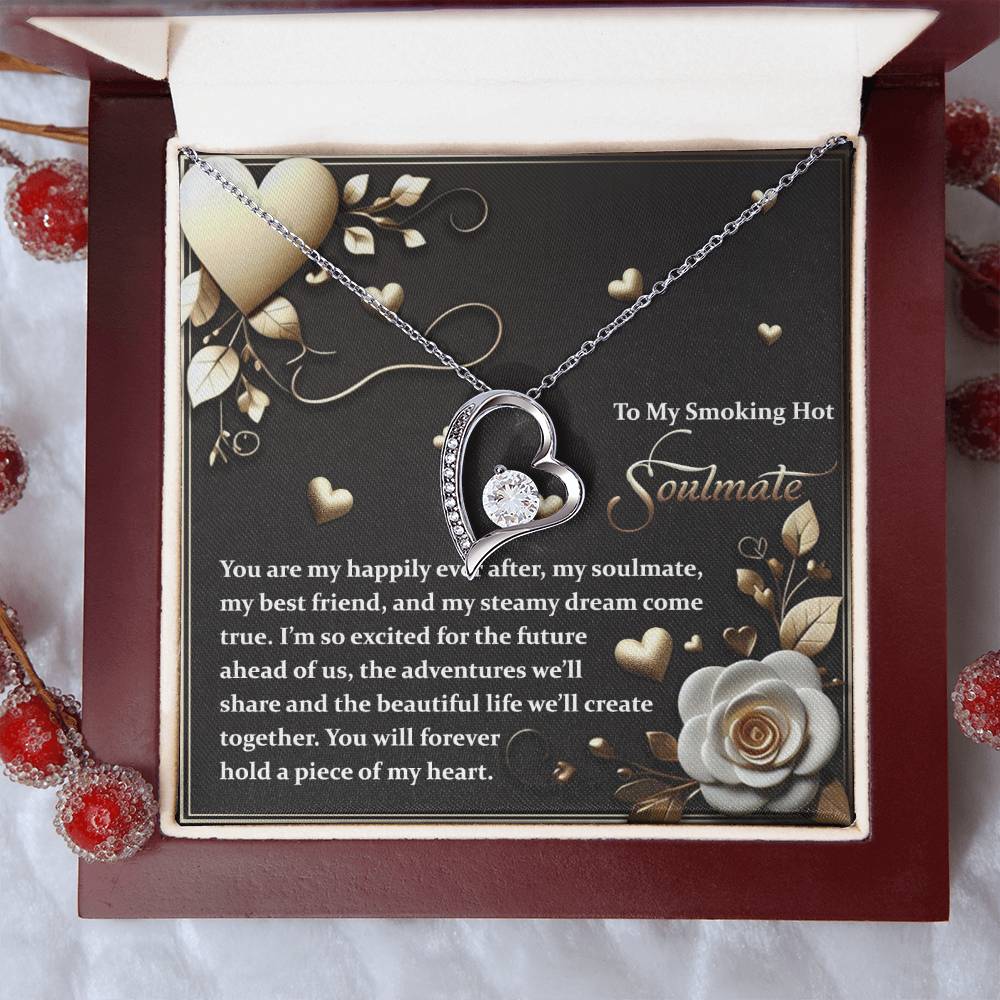 The Soulmate-The Future - Forever Love Necklace features a sparkling cubic zirconia heart-shaped pendant with a gold finish on a card in a jewelry box. Its romantic message and delicate floral design make it an ideal token of affection.