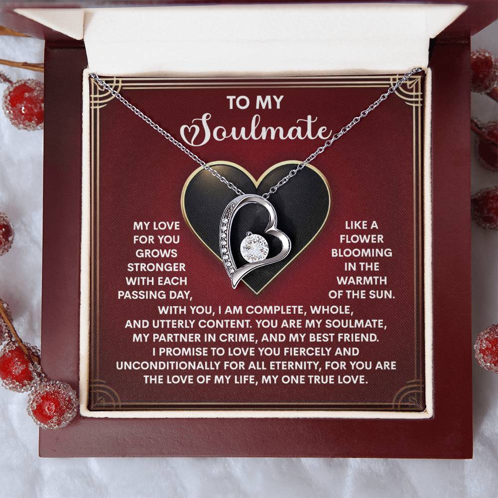 The Soulmate-One True Love - Forever Love Necklace, shaped like a heart and set with a shimmering cubic zirconia stone, is beautifully presented on a card. The card features decorative elements and a romantic message to a soulmate, embodying the essence of eternal love.