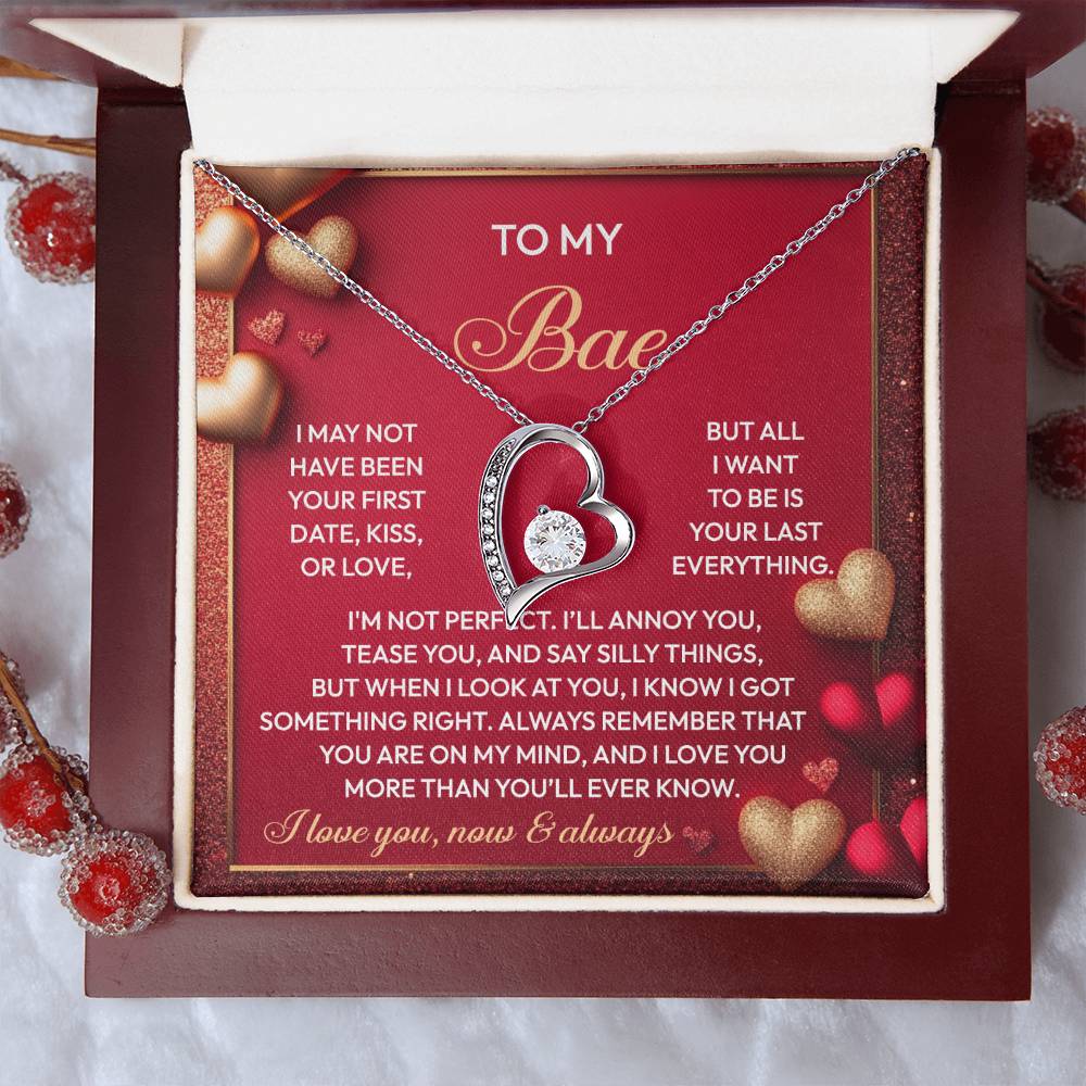 A Soulmate-On My Mind - Forever Love Necklace featuring large and small hearts rests in an open box, with its white gold finish shimmering. Inside, a heartfelt message is framed by heart graphics and adorned with dazzling CZ crystals.