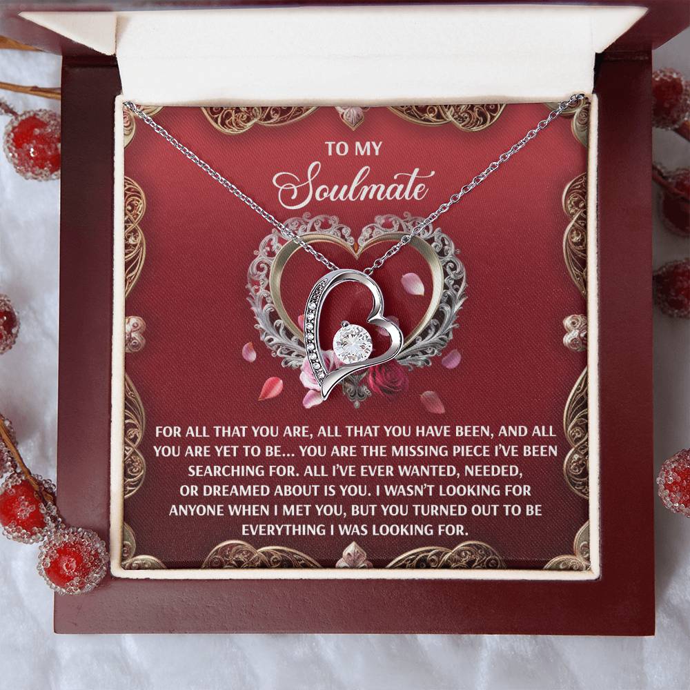 The Soulmate-I Met You - Forever Love Necklace, with intertwined heart pendants in a white gold finish, is elegantly shown in an open box. The lid features a heartfelt message to a soulmate, enhanced by a sparkling 6.5mm CZ crystal and decorative heart design.